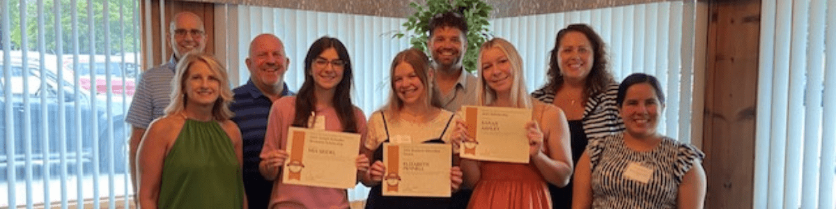 Mount Joy Chamber board members with scholarship recipients at a luncheon, highlighting community support.